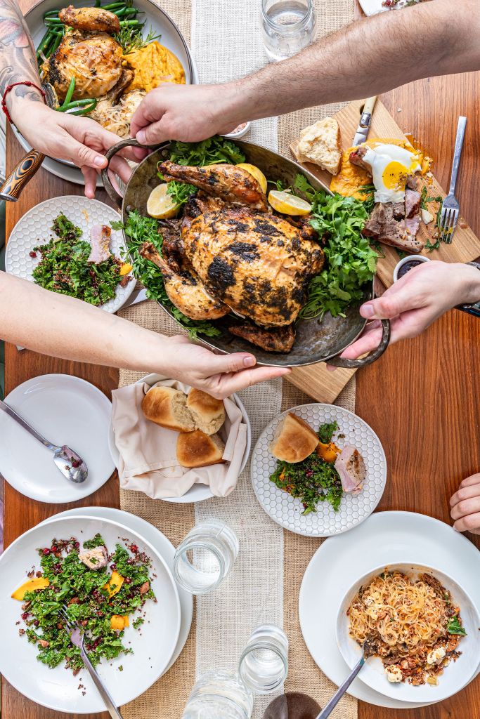 Communal table filled with abundant family-style dishes shared in a Soul Nourished gathering.
